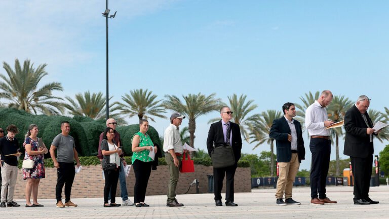 Job seekers wait in line to enter the Mega JobNewsUSA South Florida Job Fair held in the Amerant Bank Arena on April 30, 2026 in Sunrise, Florida.